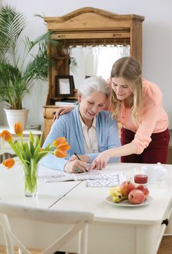 Young woman helping an elderly woman