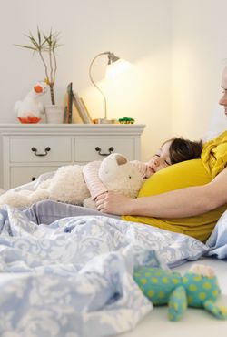 Pregnant mother with child in bed