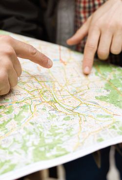 Fingers pointing at a city map